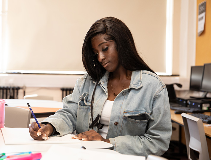 student working at desk in art studio