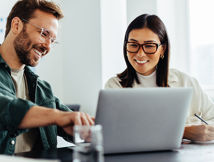 Man and women looking at a laptop